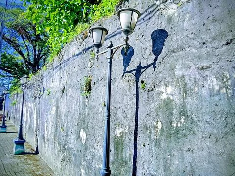 A lamppost on the street. A shadow on the wall. Stock Photos