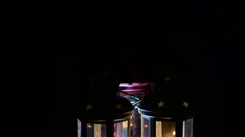 Lamps and candles on black background. Christmas theme. Stock Footage