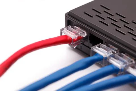 LAN network switch with ethernet cables plugged in Stock Photos