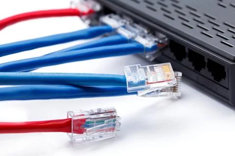 LAN network switch with ethernet cables plugged in Stock Photos