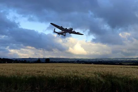 Lancaster bomber over corn fields Stock Photos