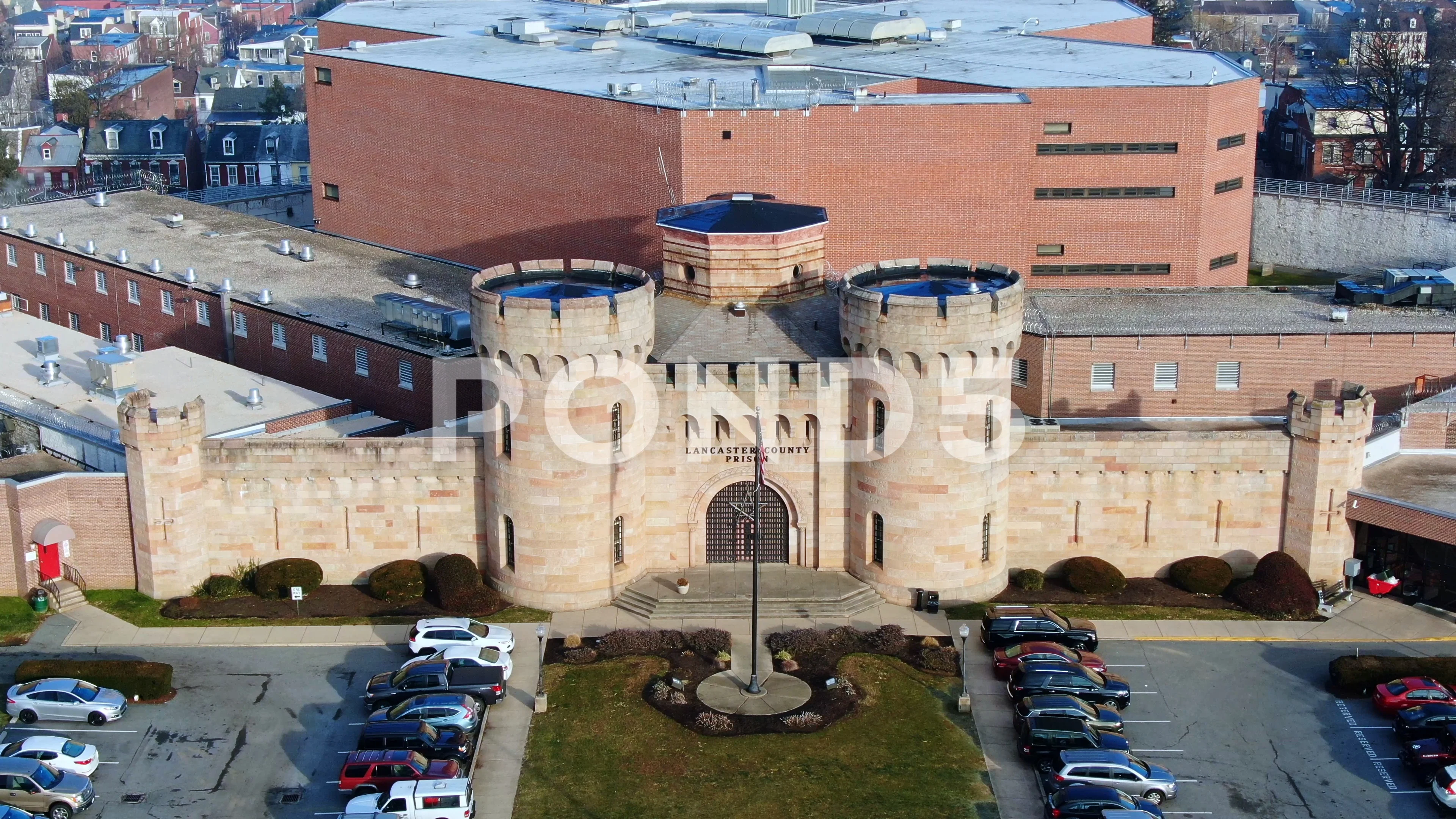 Lancaster County Prison with historic towers above main entrance, aerial