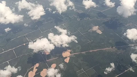 Land and white clouds looked beautiful from the airplane window Stock Footage 311307942