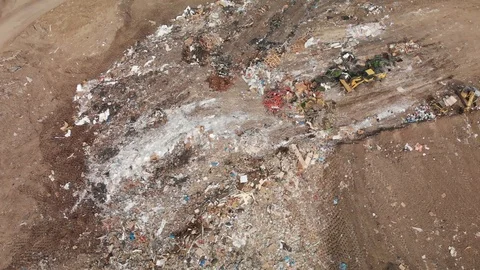 Land Fill and a machine moving trash Stock Footage 120814407