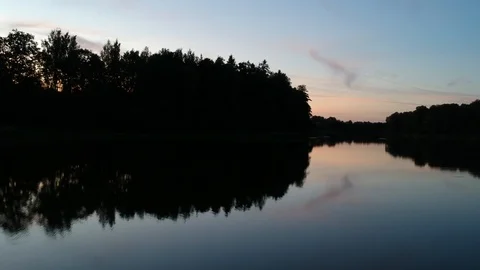Land of lakes at sunset forest reflection Stock Footage 111385105