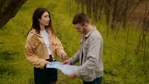 Land navigation, maps, and navigation tools. Travelers with a map search for a t Stock Footage 271556735