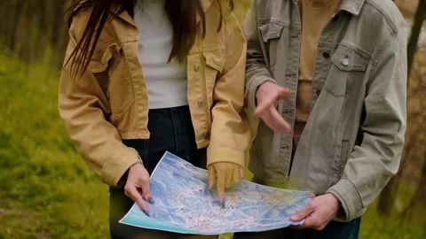 Land navigation, maps, and navigation tools. Travelers with a map search for a t Stock Footage 271556738