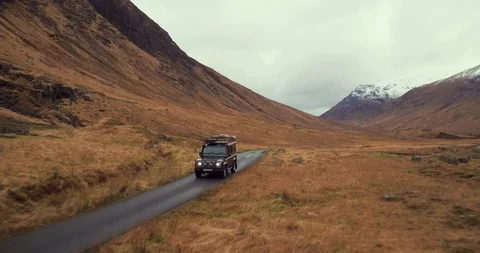 Land Rover Defender adventuring across Glen Etive valley drone aerial 4K Stock-Footage 104583386