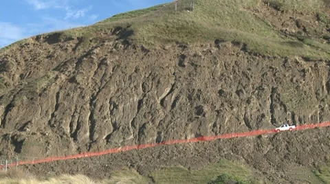 Land slips around eroded road Stock Footage