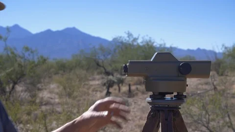A land surveyor checking property boundaries in the desert 库存影片 89809218