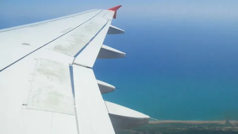 Land under the clouds, mountains, rivers, seas from the altitude of the airplane Stock Footage 92043755