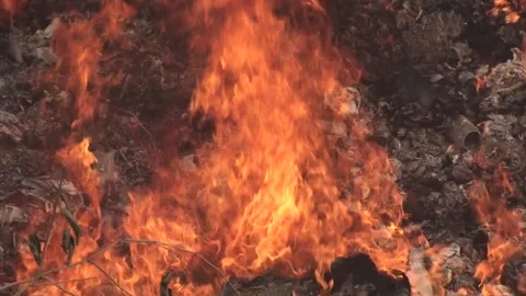 Landfill fire, burning garbage, thick smoke rising, very close-up shot of a fire Stock Footage 130742780