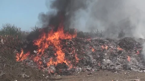 Landfill fire, burning garbage, thick smoke rising, close-up shot of afire Stock Footage 130742848