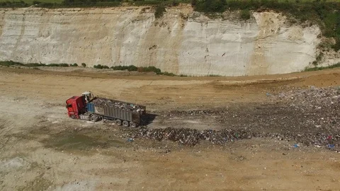 A landfill lorry is unloading garbage into junkyard. Aerial shot. Stock Footage 94740280