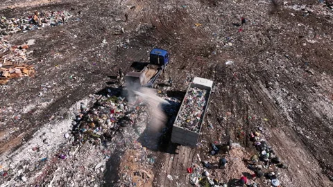 Landfill with solid household waste. Garbage truck unloads rubbish 動画素材 211440940