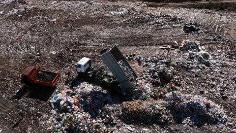 Landfill with solid household waste. Garbage truck unloads rubbish 動画素材 211904401