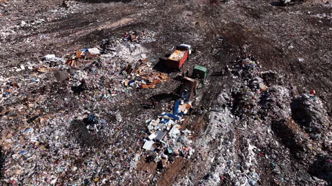 Landfill with solid household waste. Garbage truck unloads rubbish Видео 212021852