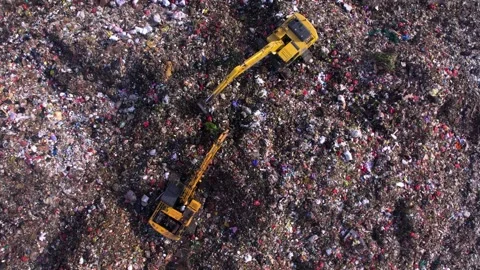 Landfill with unsorted plastic. Excavator working on the top of waste pile Stock Footage 295954817