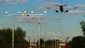 Landing aircraft with shadow above earth, landing light posts HD Footage