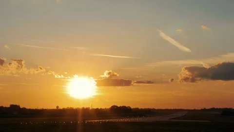 Landing airplane in airport runway at dusk sunset. Dynamic close up shot filmed Stock Footage