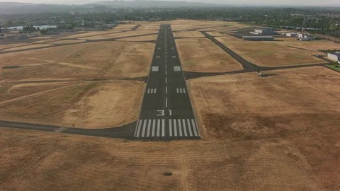 Landing on airport runway.  Shot with Cineflex and RED Epic-W Helium. Stock Footage
