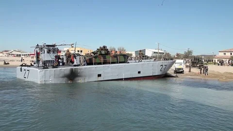 Landing craft loads ambulance on beech Видео 76152676