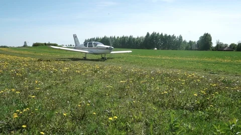 Landing light aircraft on the field Stock Footage 127024203