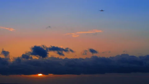 Landing of the plane against the backdrop of a beautiful Sunset and blue Clouds. Stock Footage 150070151