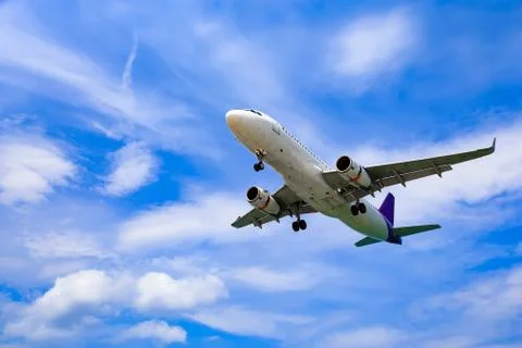 Landing plane in clouds Stock Photos