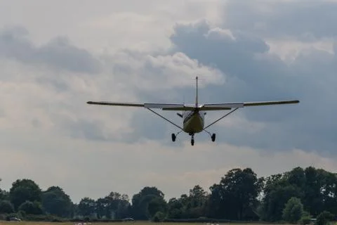 A landing  plane on a gray background Stock Photos