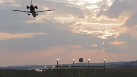Landing with strong side wind against the sunset sky. Video stock 106268035
