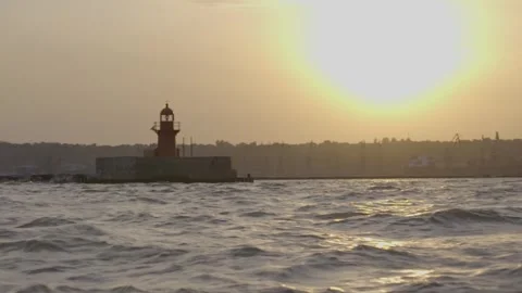 Landmark lighthouse, shoreline and building on coastline, maritime seaport Stock Footage 287084792