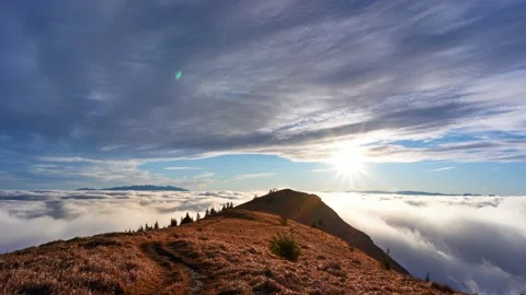Landscape above the clouds. Clouds spill over a grassy hill in a national park. Stock Footage 165601898