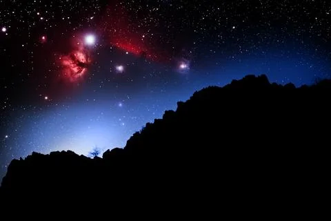 Landscape with alpine mountain, low clouds, purple starry sky with nebula Stock Photos