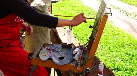 Landscape artist paints in oils mixed on the palette output circuits painting Stock Footage