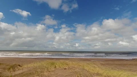Landscape of a beach seen from the sand dunes. blue sky with clouds, sea wi.. Stock Footage 252397569