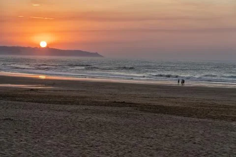 Landscape on a beach when the sun is setting in a nice sunset Stock Photos