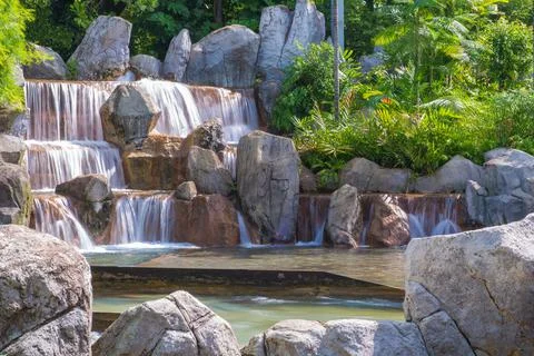 Landscape of beautiful Artificial waterfall in garden at the public park Stock Photos