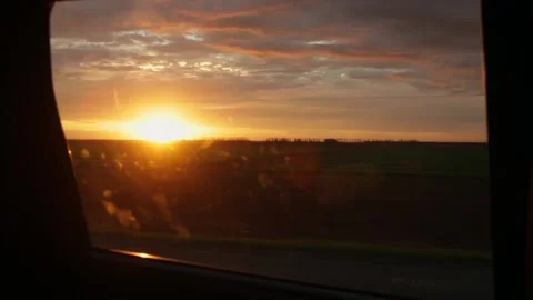 Landscape with beautiful sunset view from car window driving on road trip in the Stock Footage 146910658