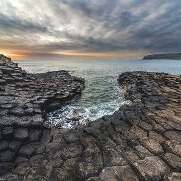 Landscape with black volcanic basalt columns on rocky beach by the sea. Da Da Stock Photos