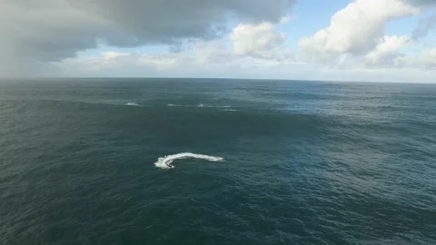 Landscape of broad never ending ocean with professional surfers on jet skis Stock Footage 156093190
