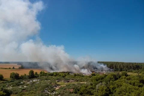 Landscape of burning waste dump Stock Photos