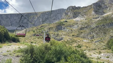 Landscape cable car moving over Montenegro valley with clear sky Stock Footage 319442166