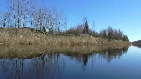 Landscape calm river and shores with forest reflected in the water. Stock Footage