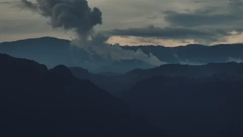 Landscape capture of many clouds and fog rising from mountain peaks in the .. Video stock 277536806