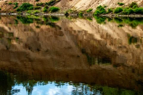 Landscape with cliff reflection in river. Stock Photos