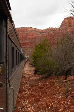 Landscape of cliffs and reddish rocks while on a train Stock Photos