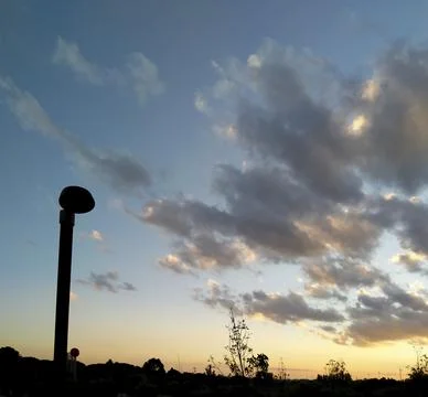 Landscape with clouds at sunset Stock Photos