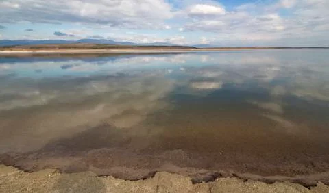 Landscape in the cloudy sky reflected in a dam. Stock Photos