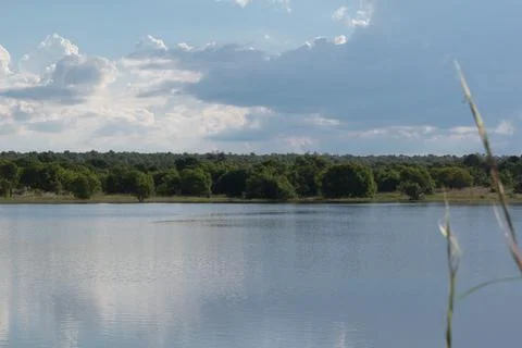 Landscape of a cloudy sky reflected on the lake. Stock Photos